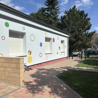 Bild vergr&ouml;&szlig;ern: Der Bereich zur Stra&szlig;e mit den Fahrzeugen der Kinder am linken Bereich geparkt.